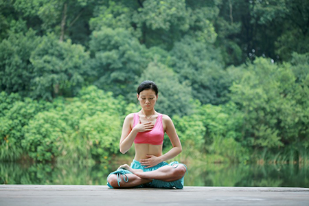 Lady on Dock Doing Breathing Exercise